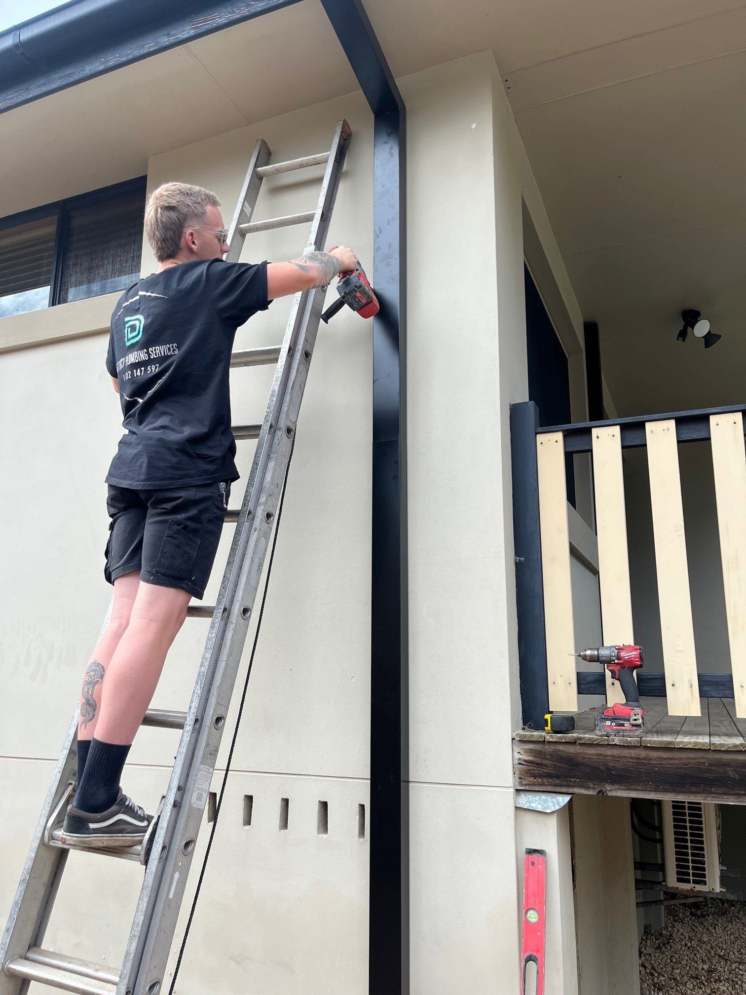 Hands Of Plumber With A Wrench Fixing The Water Pipe — Distinct Plumbing Services In Flinders NSW