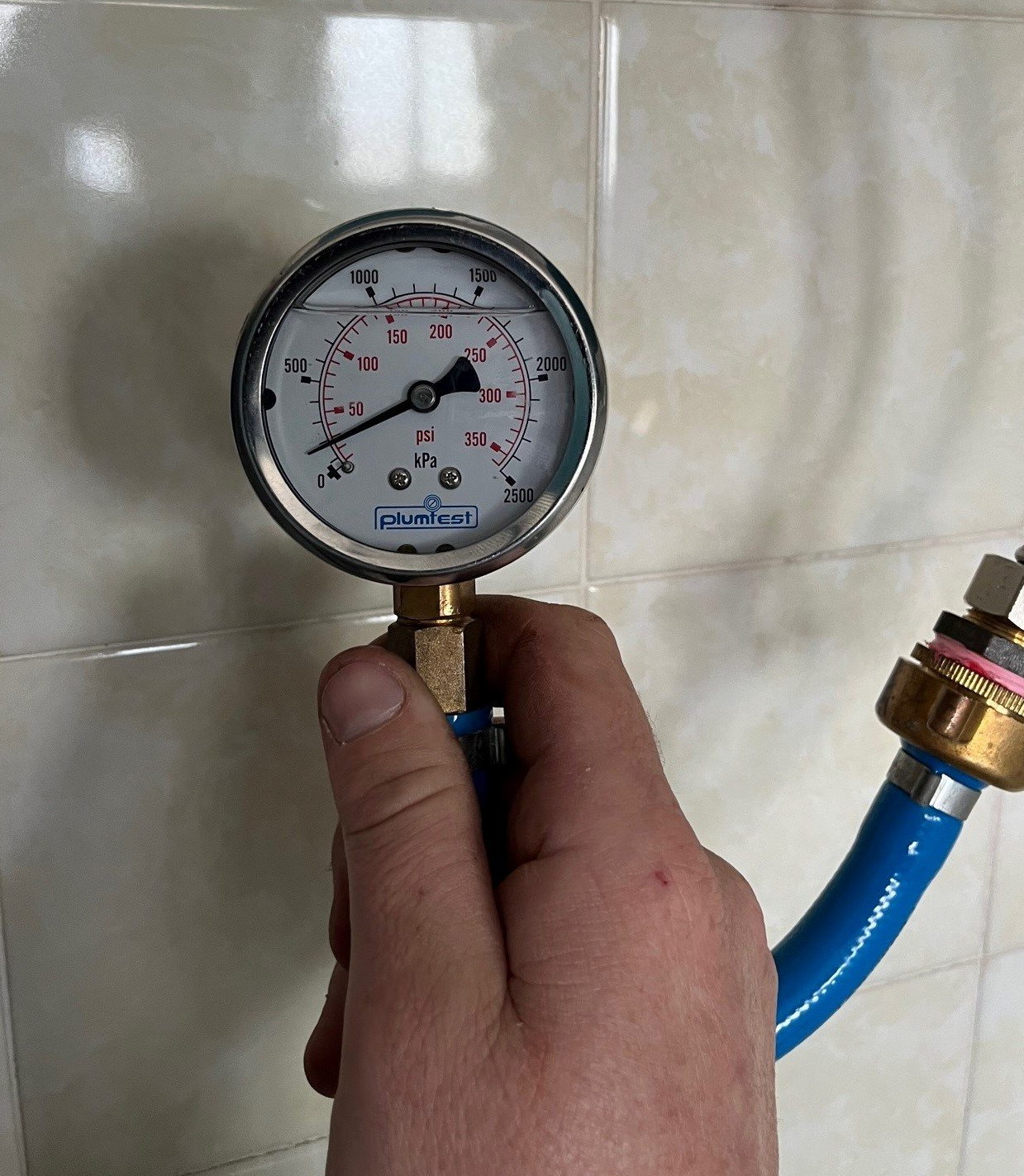 Male Plumber Fixing White Sink Pipe With Adjustable Wrench — Distinct Plumbing Services In Flinders NSW