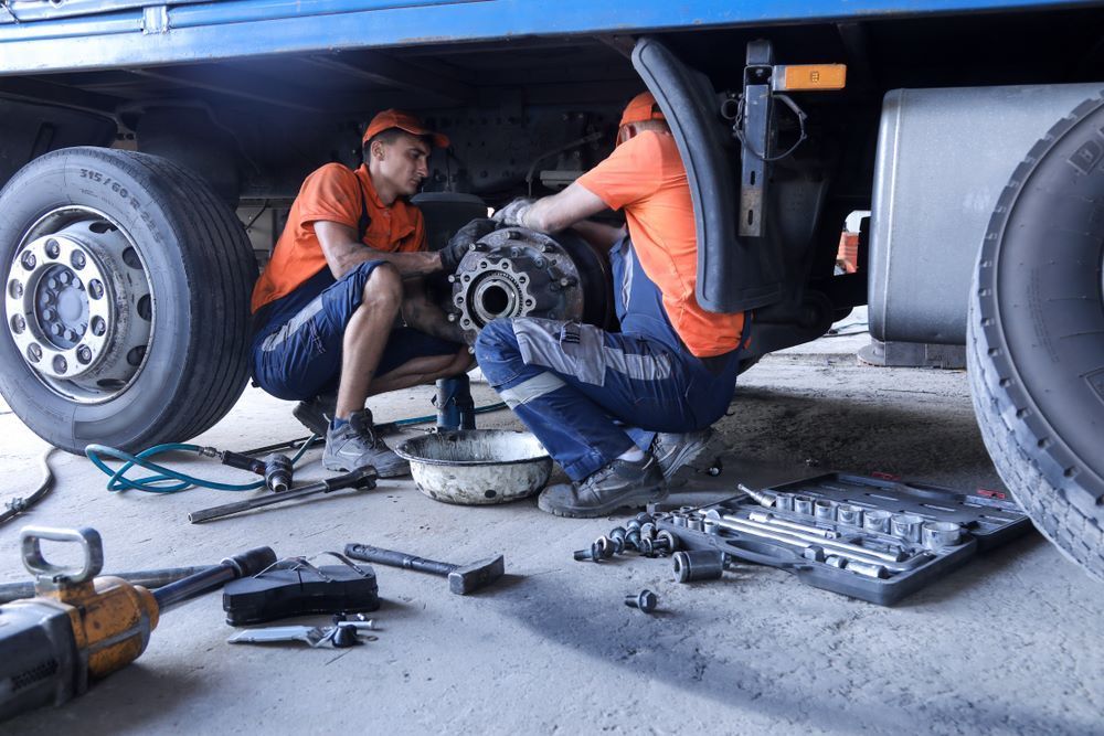 Two Men Are Working on a Truck in a Garage — Camden Haven Panel Works In Laurieton, NSW