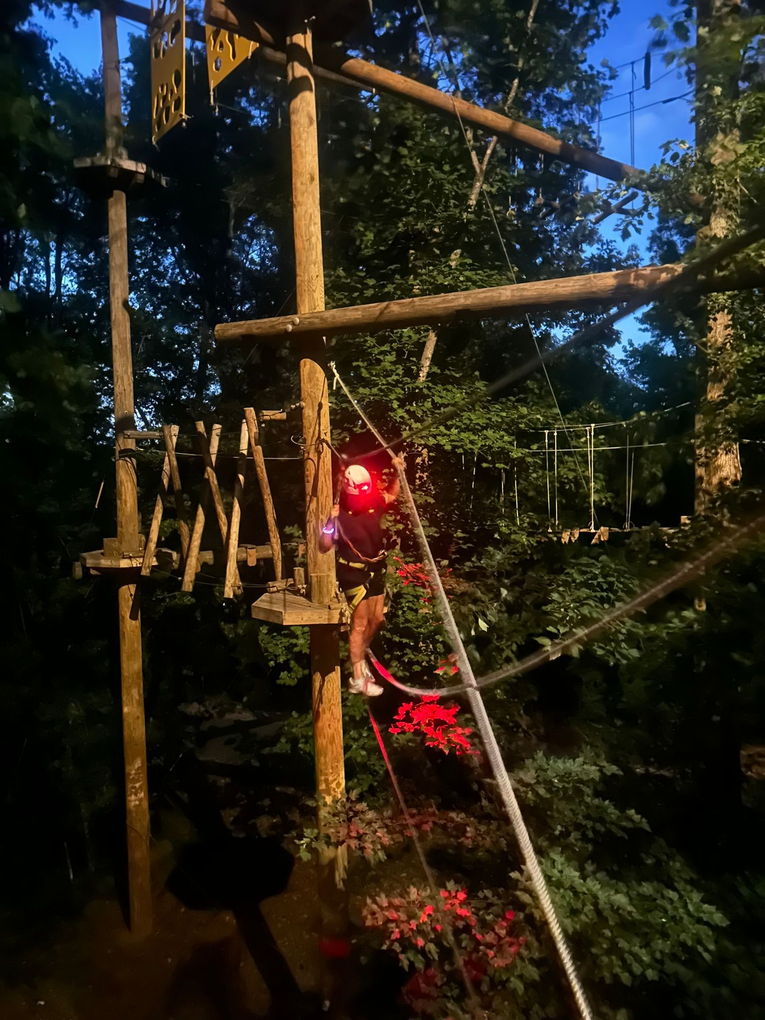 Climber on the course at dusk with a head lamp