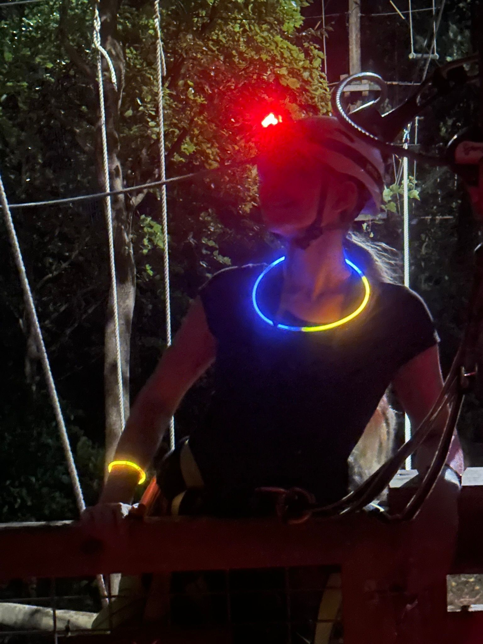 Guest with a glow stick on the course at night