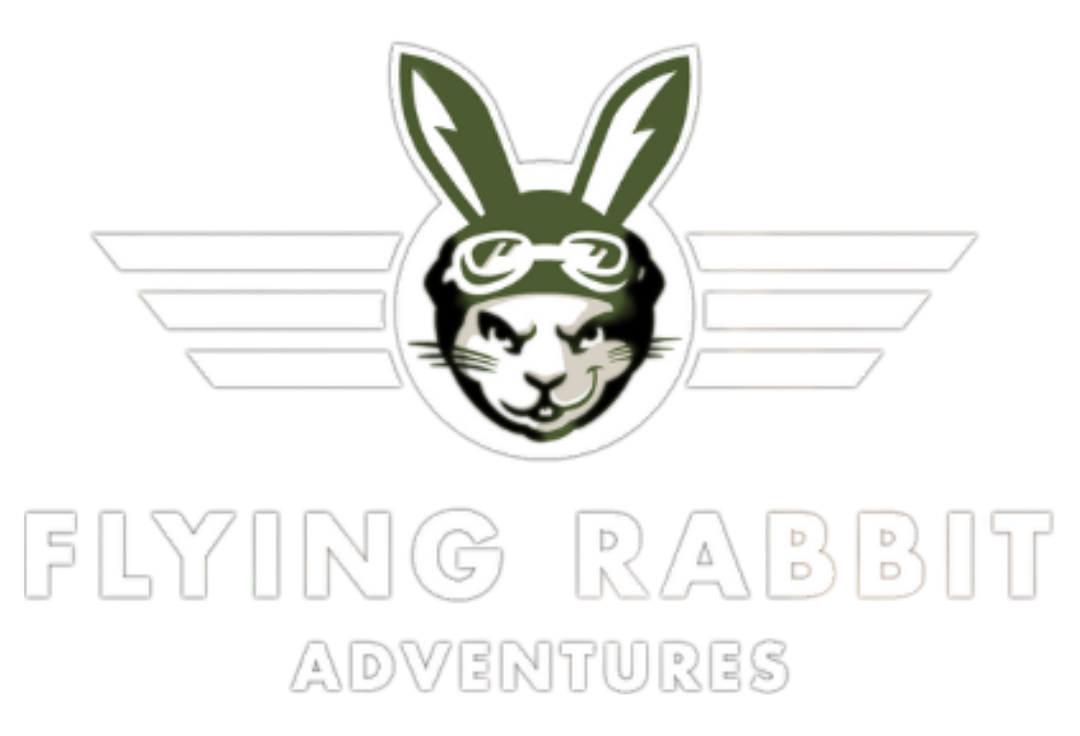 Logo for Flying Rabbit Adventures: a green rabbit wearing goggles, inside of a white winged emblem. Below, text reads