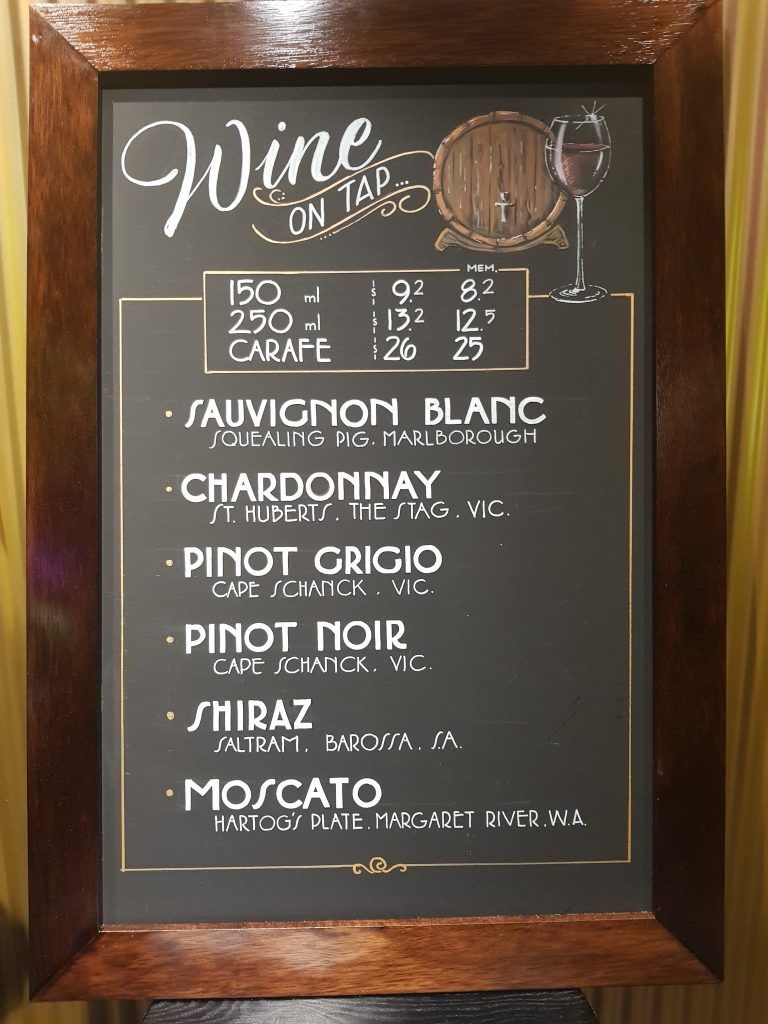 A chalkboard with a list of wines on it