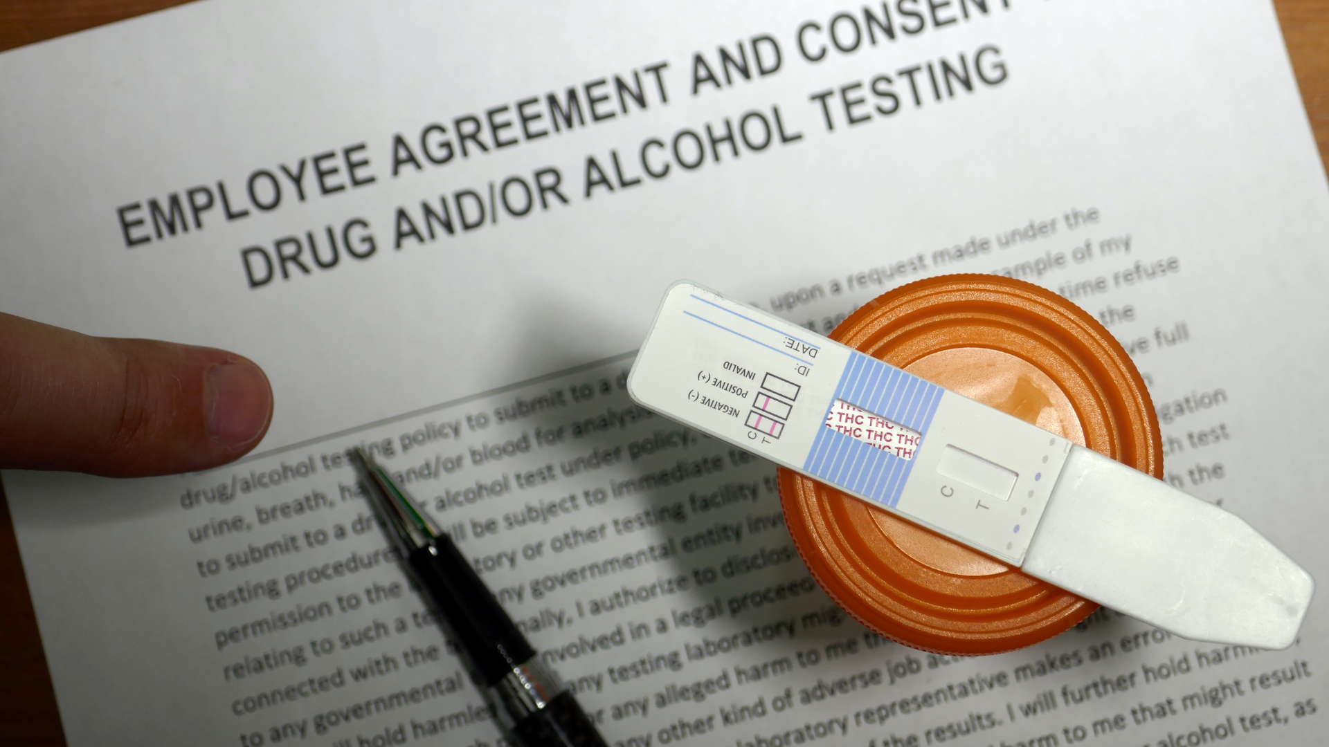 Employee agreement with drug test and pen.