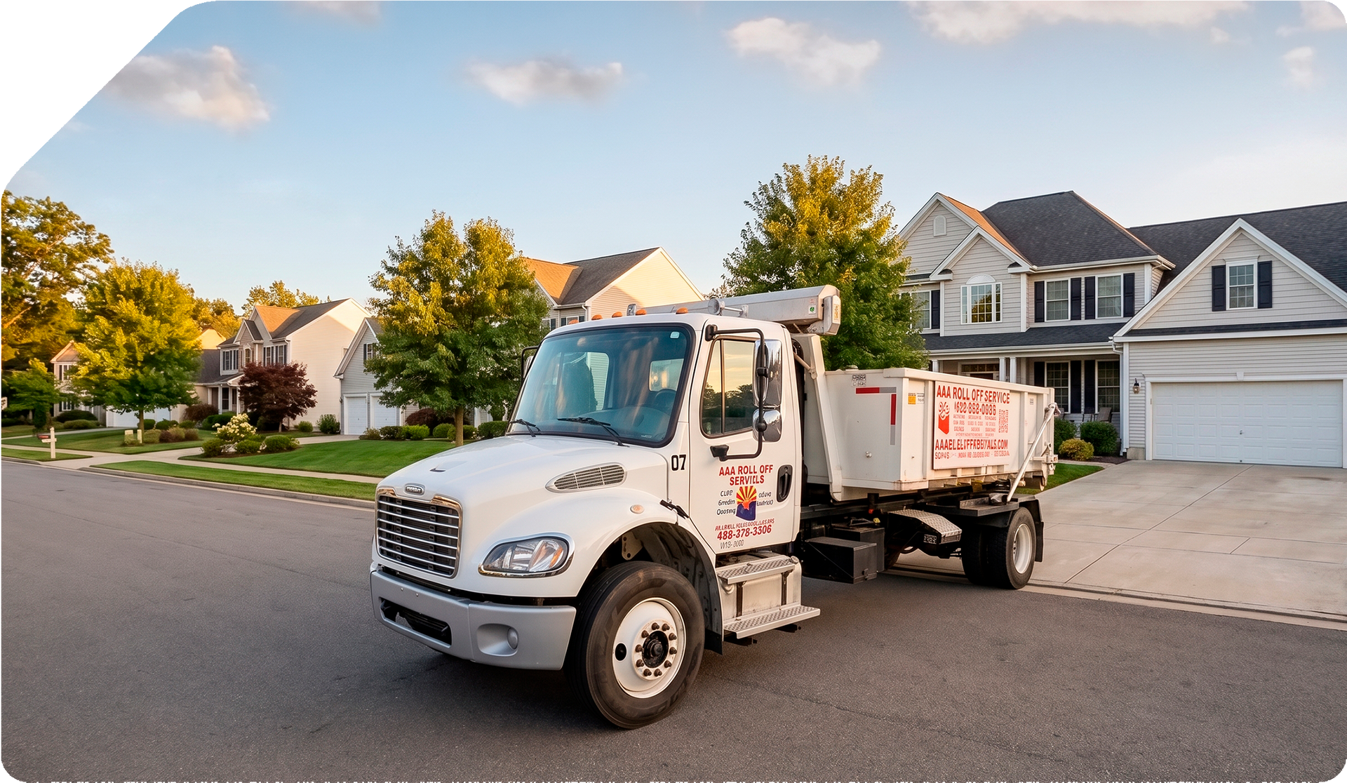 White dump truck parked on a suburban street in front of houses at sunset