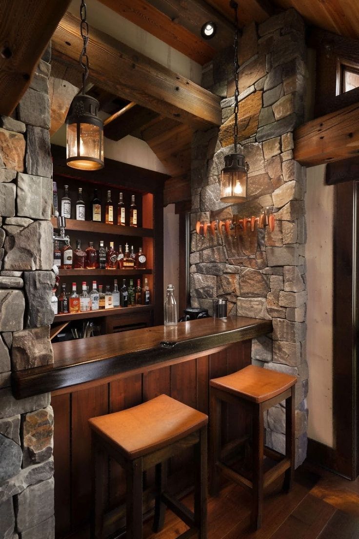 A bar with two stools and a stone wall