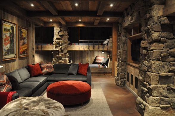 A living room with a couch and a red ottoman