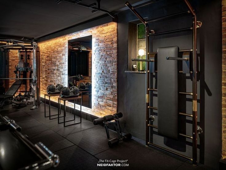 A gym with a lot of equipment and a brick wall.