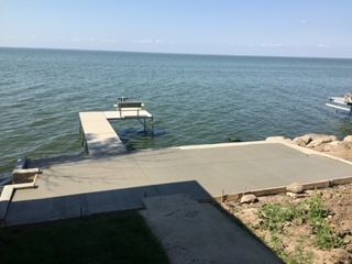 A dock  on the shore of a lake.