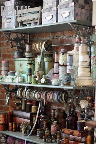 A shelf filled with lots of ribbons and boxes.