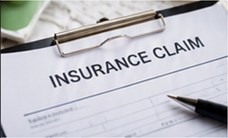 Insurance claim form on clipboard with pen on desk