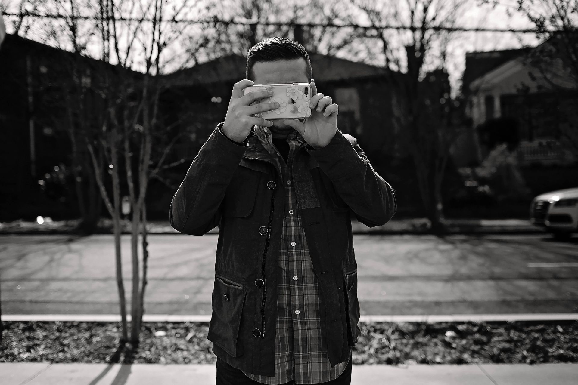 A man is taking a picture with his cell phone.