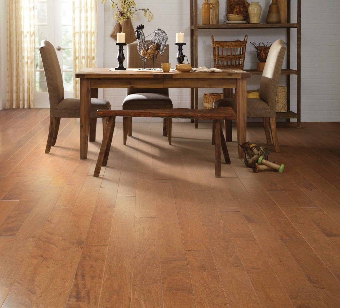 Wooden dining room with a table, chairs, and warm-toned hardwood floor
