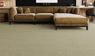Modern living room with a brown sofa, chaise lounge, and desk on a green carpeted floor