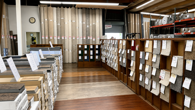 Rows of display boards and papers in a classroom or office, with wood flooring and shelves along the walls