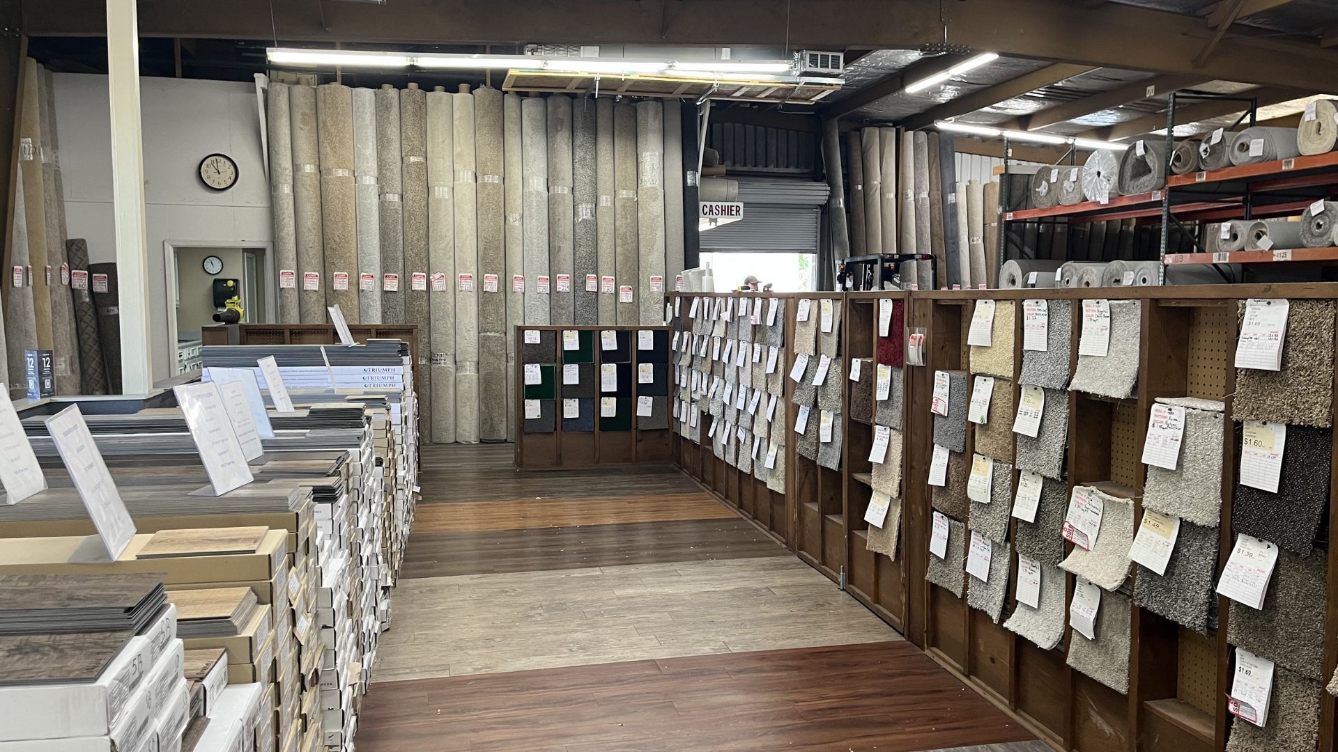 Industrial mailroom with stacked papers and labeled cubbies along wooden walls and tables