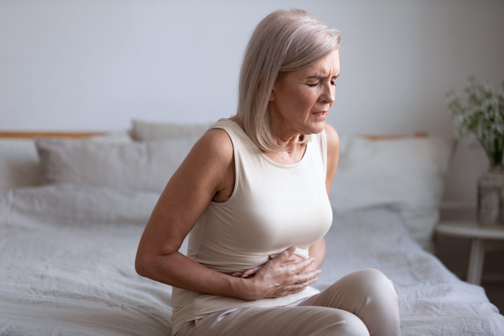 Woman holding her stomach in pain.