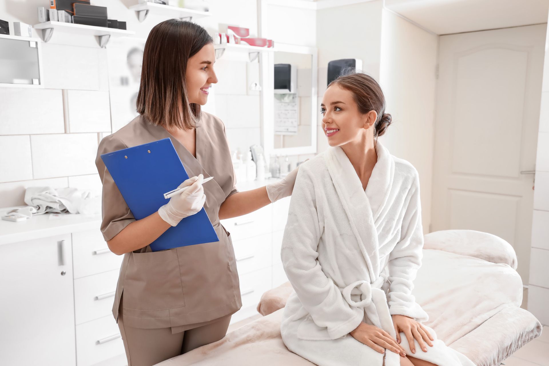 Healthcare provider speaking with a patient in a bright spa-like treatment room