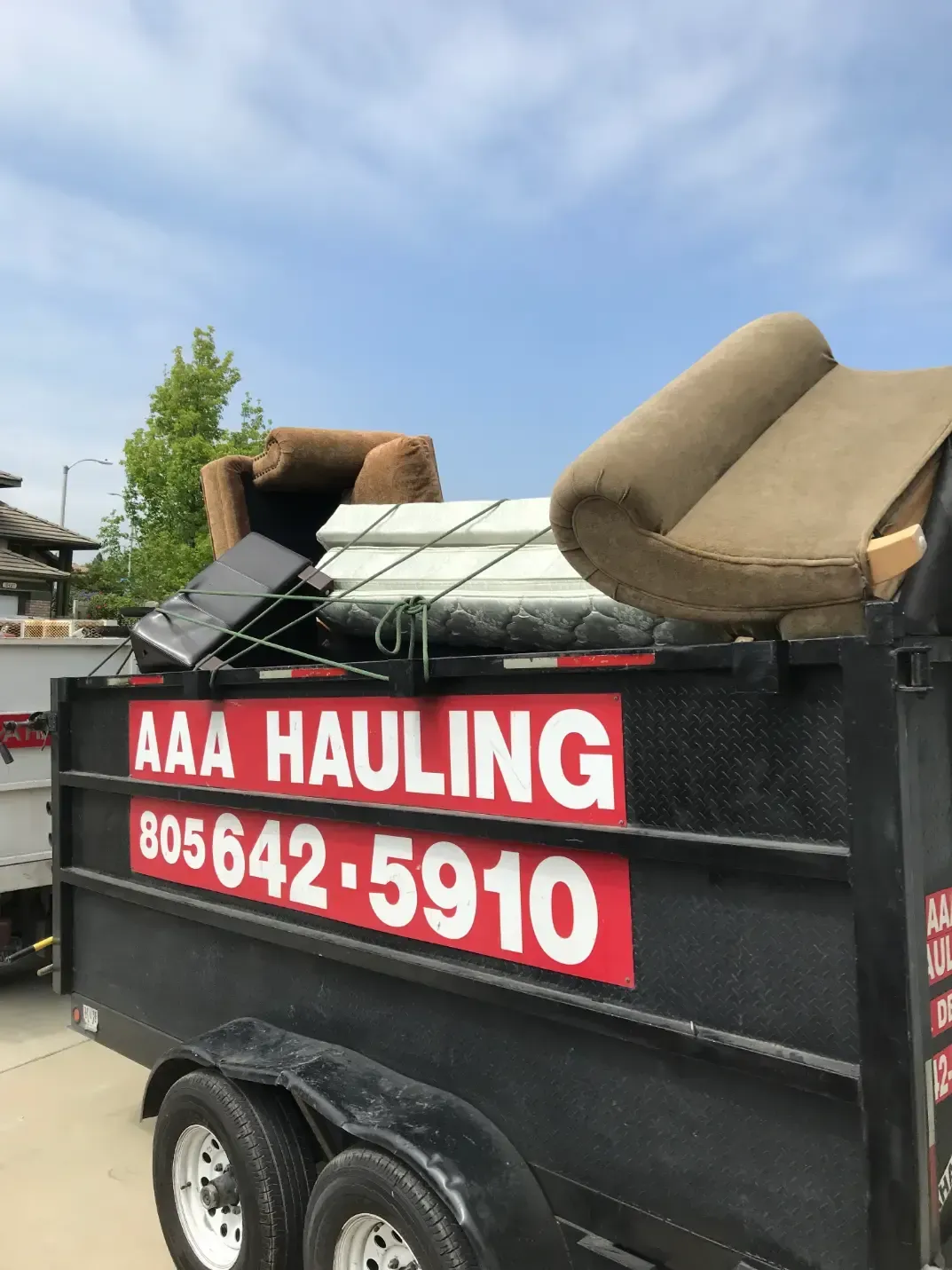 A dumpster that says aaa hauling on it