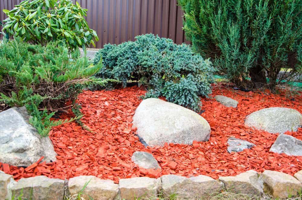Garden With Red Bark Mulch and Large Grey Rocks — Ourimbah Landscape Supplies In Ourimbah, NSW