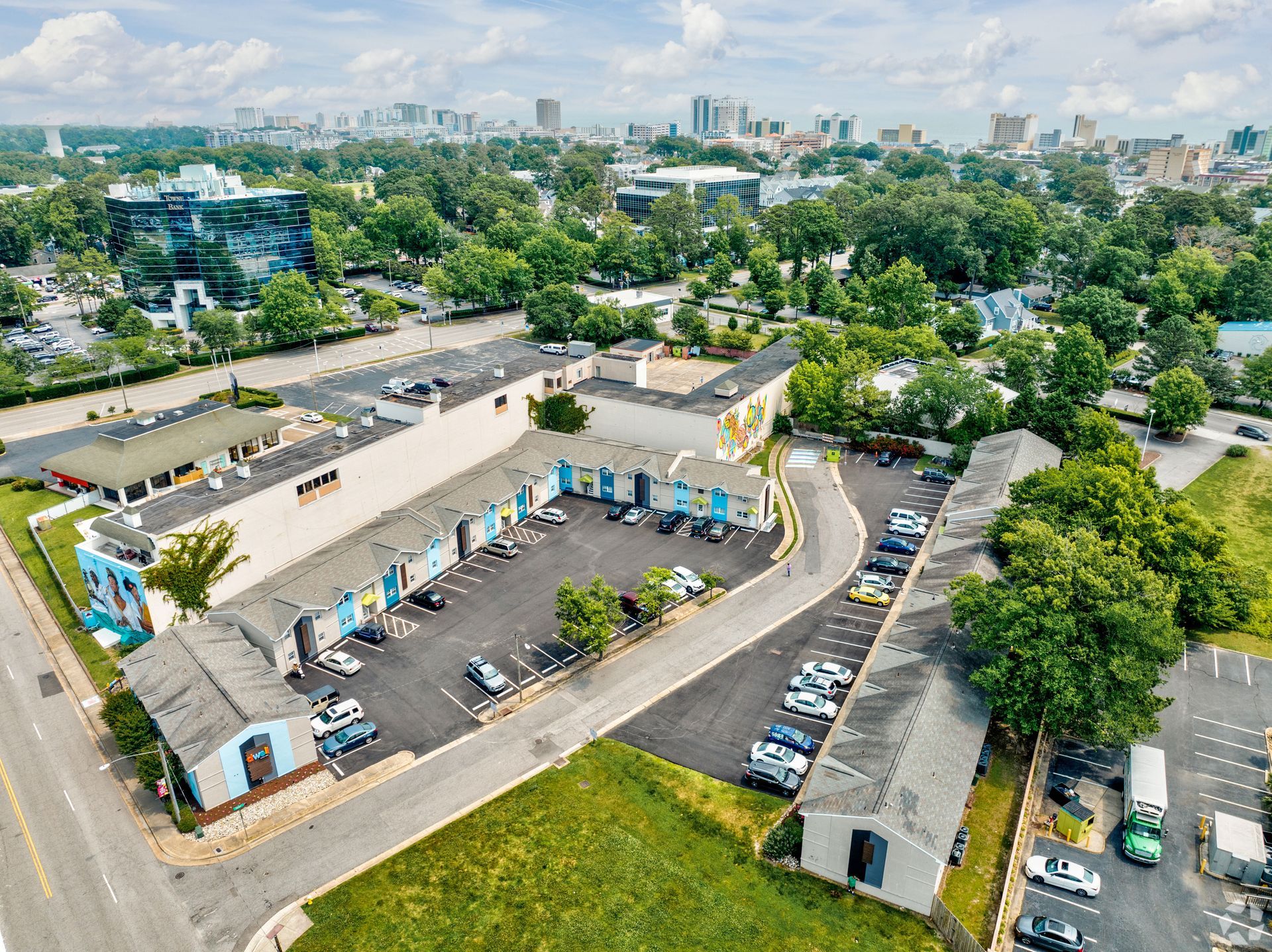 An aerial view of a large building with a lot of cars parked in front of it.
