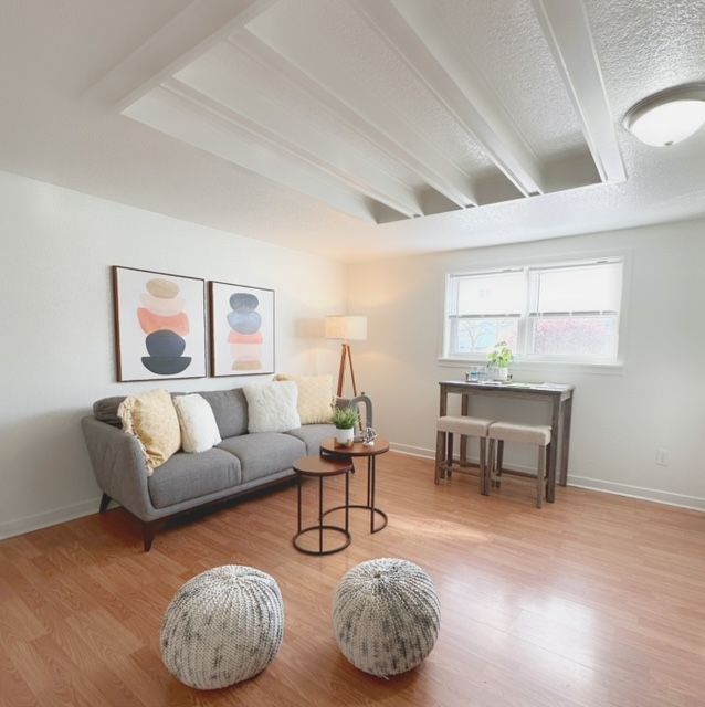 A living room with a couch and two ottomans