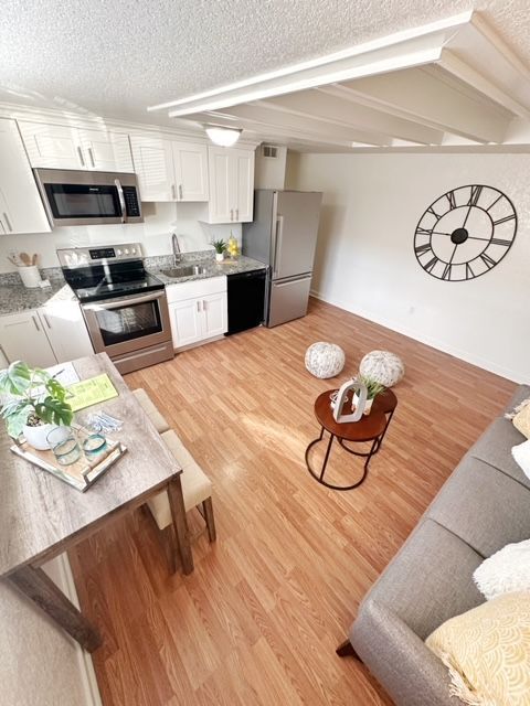 A living room with a couch and a clock on the wall