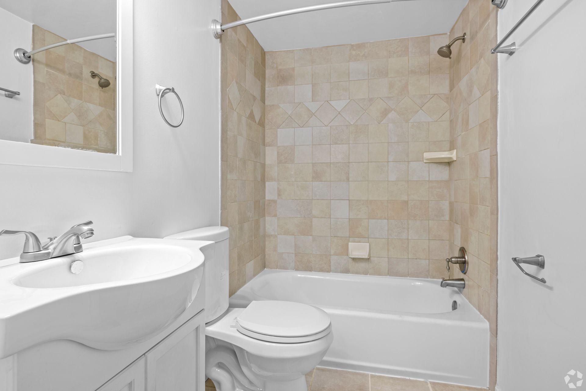 A bathroom with a toilet , sink and bathtub.