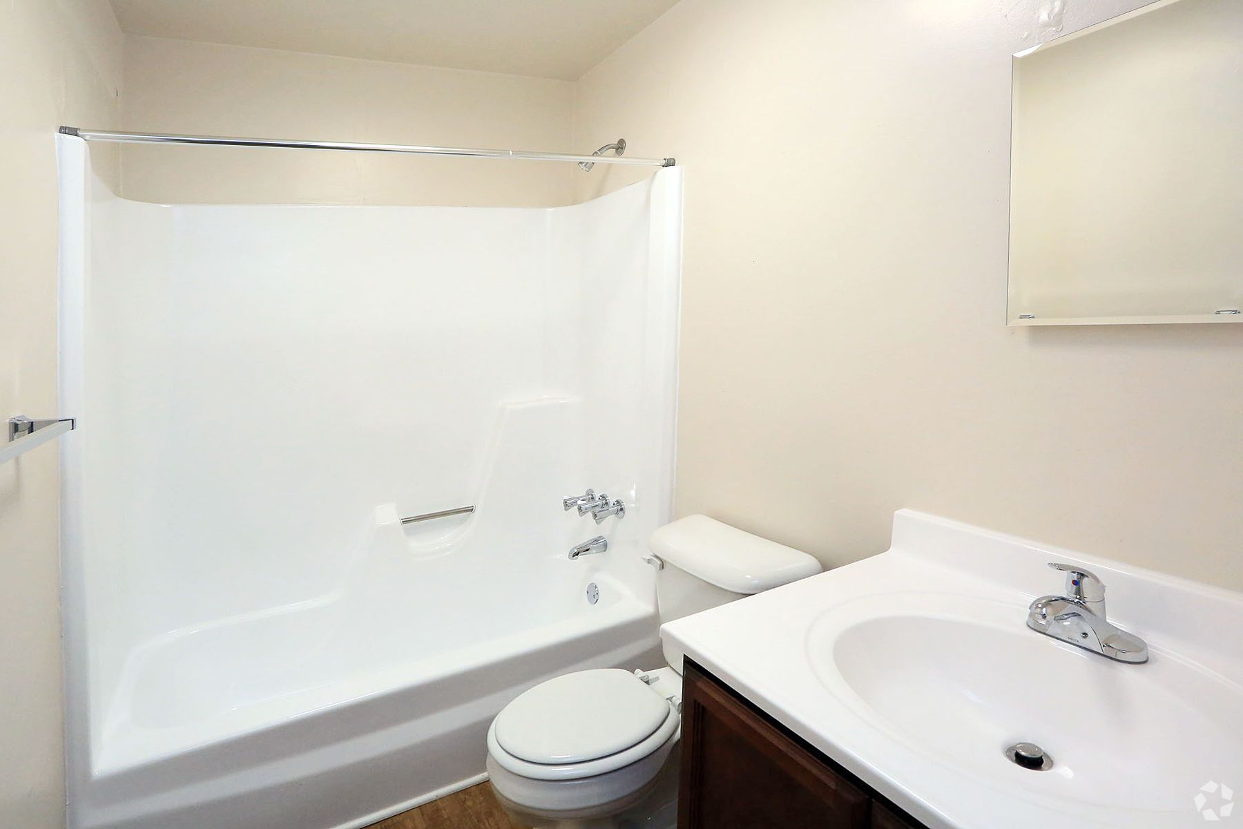 A bathroom with a toilet , sink and bathtub.