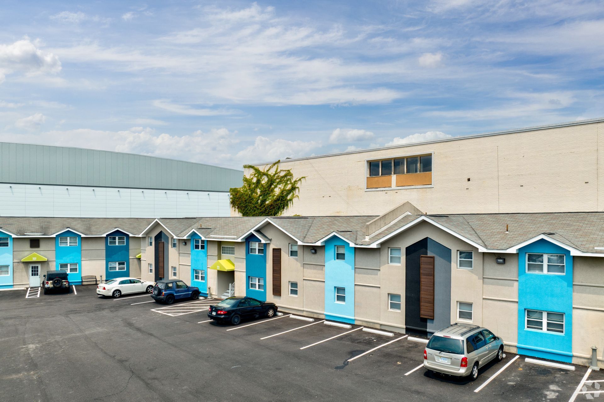 A building with a lot of cars parked in front of it