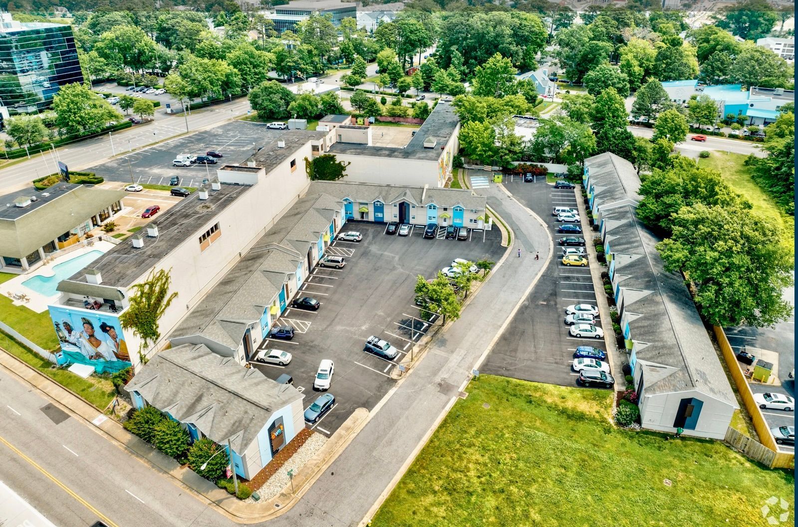An aerial view of a city with a lot of buildings and parking lots