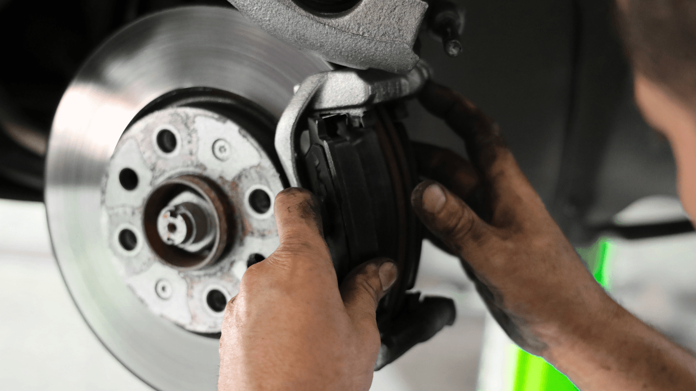 a picture of a mechanic changing brake pads