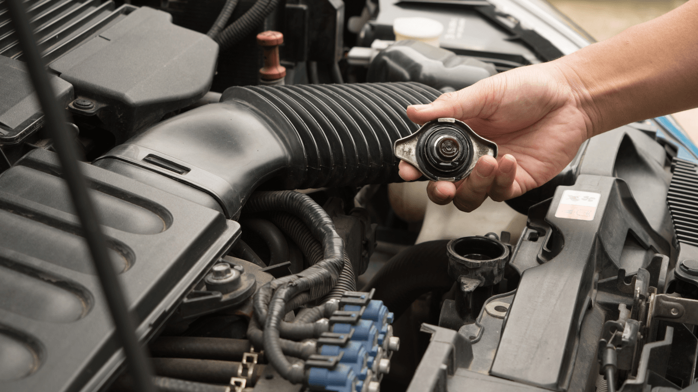 a mechanic opening radiator fluid cap