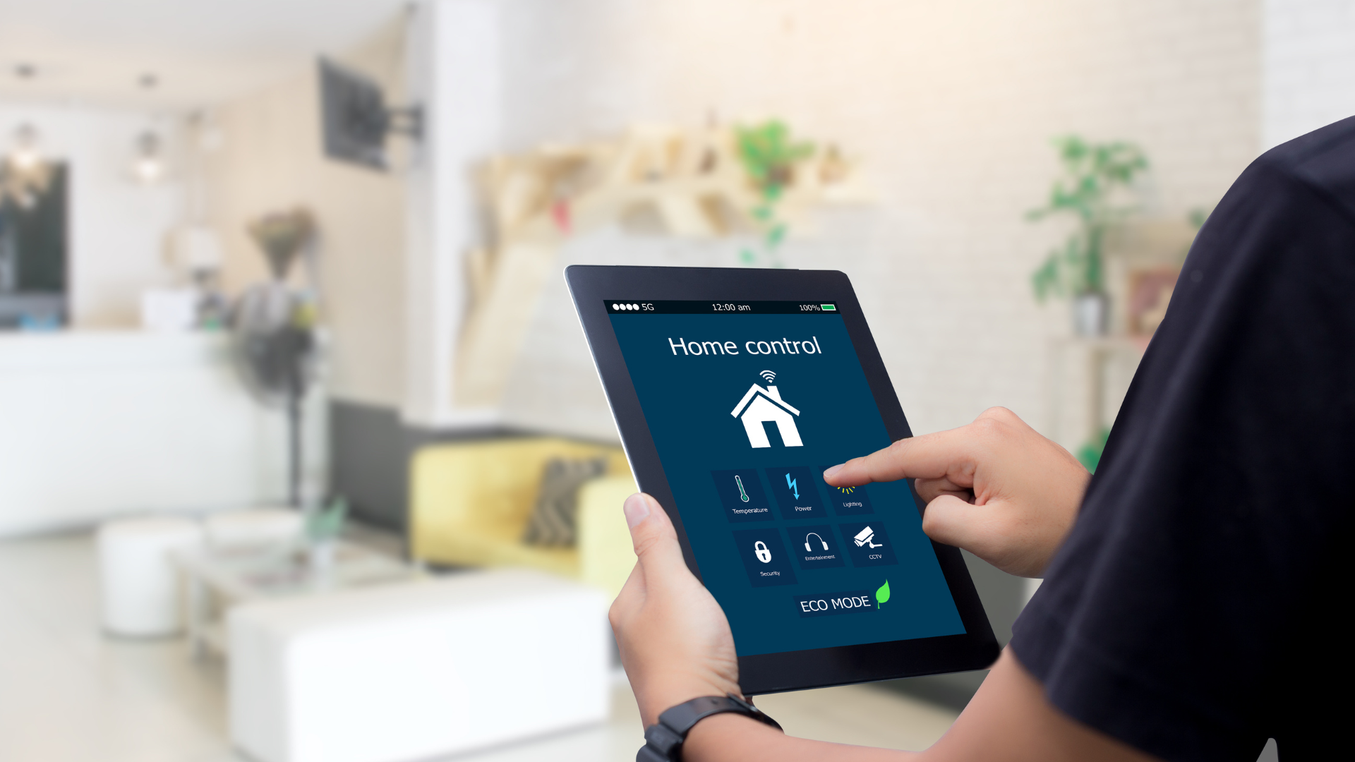 Person using a tablet to control a smart home in a bright living room
