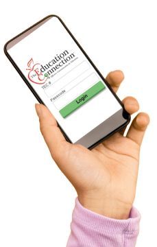 A hand holds a smartphone displaying a login screen for