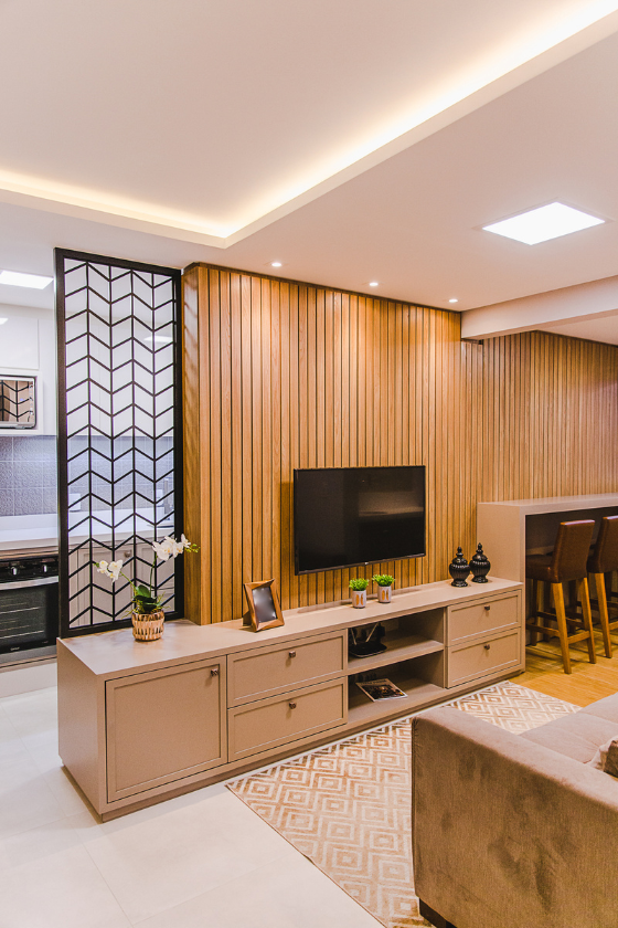 A living room with a flat screen tv on the wall.