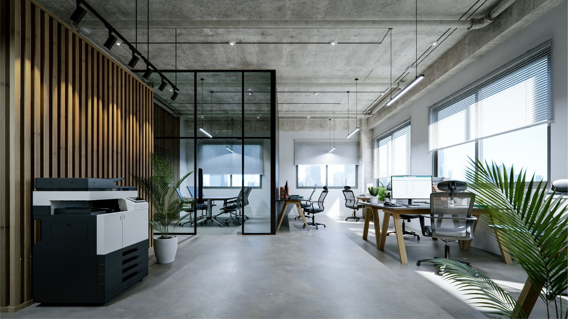 A modern, open-plan office with concrete ceilings, a glass-walled conference room, wooden slat wall, and desks.