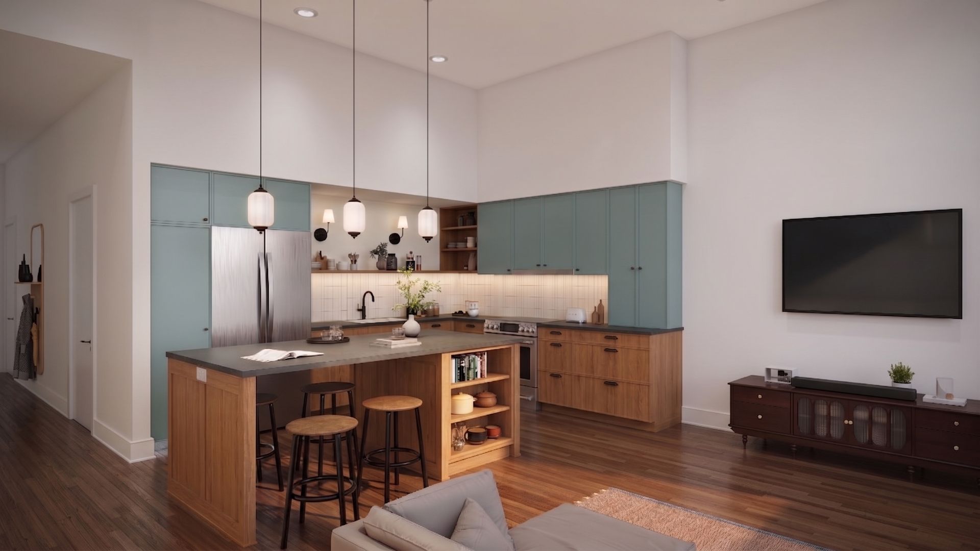 Modern open-plan kitchen and living room with island, teal cabinets, wall-mounted TV, and hardwood floors