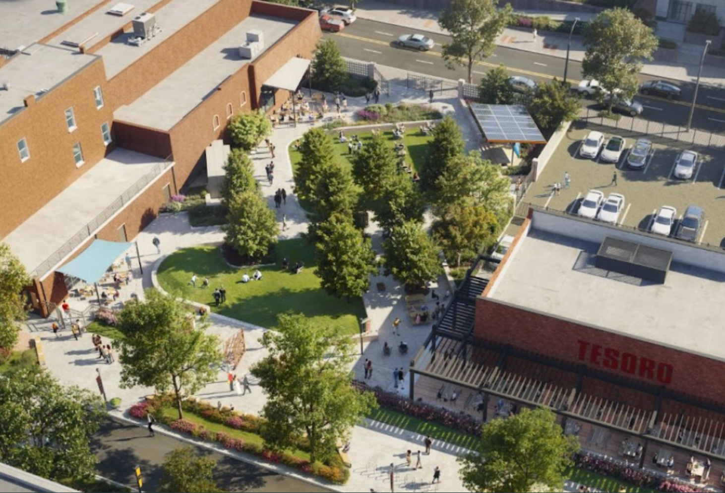 Aerial view of a campus courtyard with trees, paths, benches, and surrounding buildings and parking lot