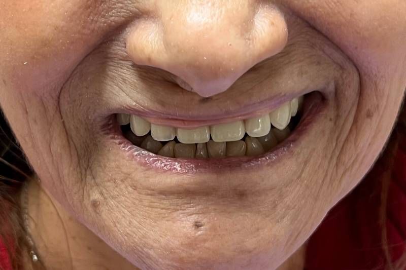 A close up of a woman 's face with a smile on her face.