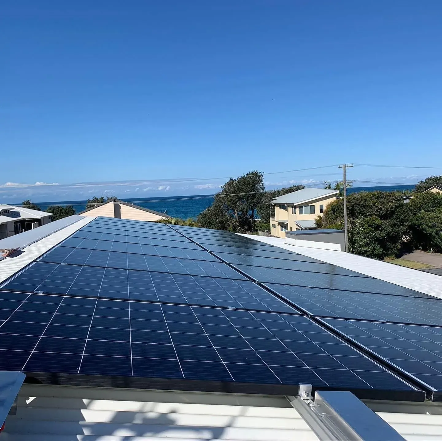 A Man Is Working On A Solar Panel With A Drill — Forster Solar and Lighting In Tuncurry, NSW