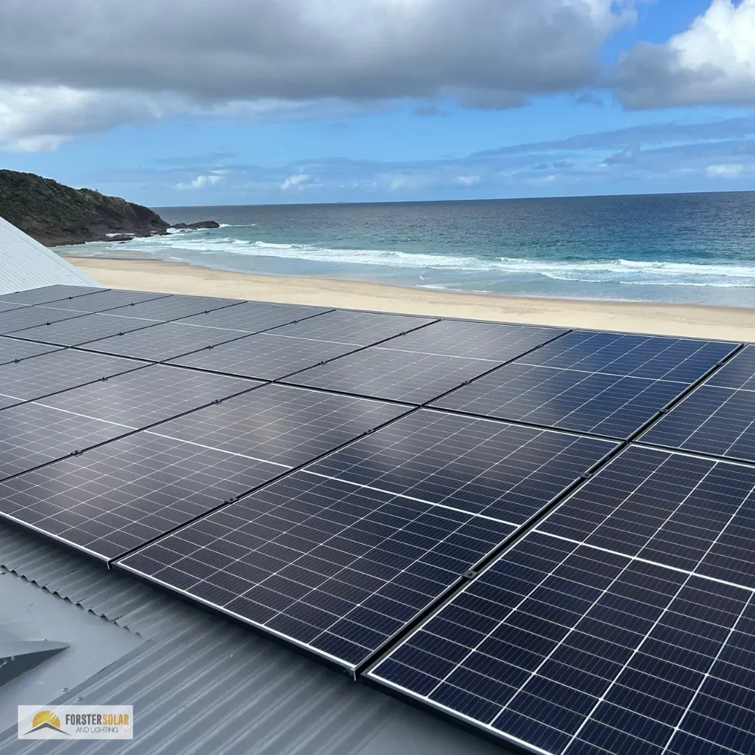 A Person Is Touching A Solar Panel With Their Hand — Forster Solar and Lighting In Tuncurry, NSW