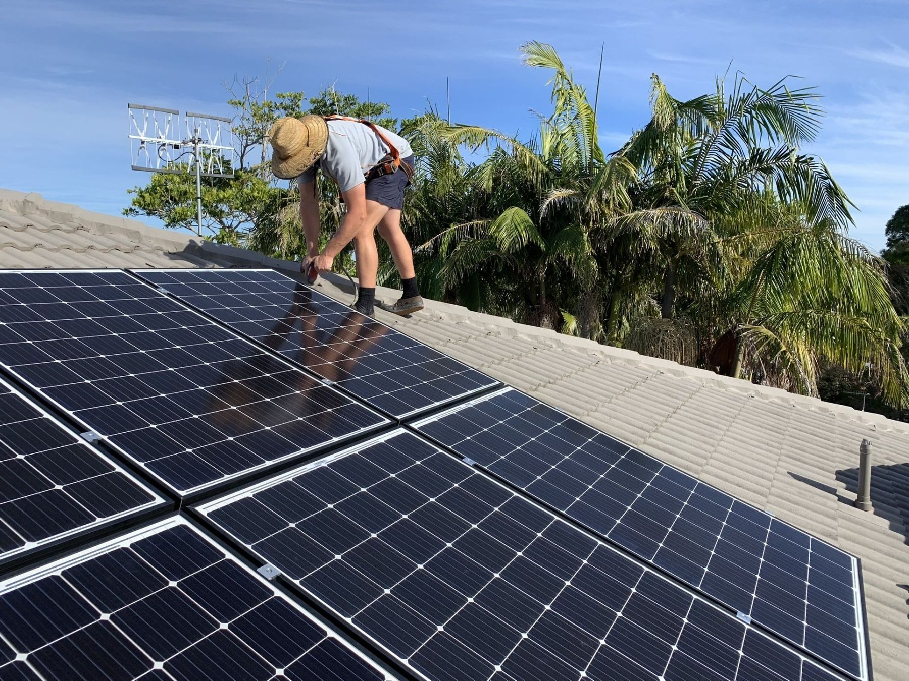 A House With A Wooden Fence And Solar Panels On The Room — Forster Solar and Lighting In Nabiac, NSW