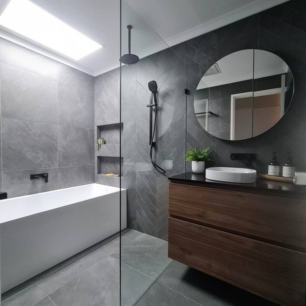 A Bathroom With A Bathtub, Sink, Shower And Mirror — Forster Solar and Lighting In Forster, NSW