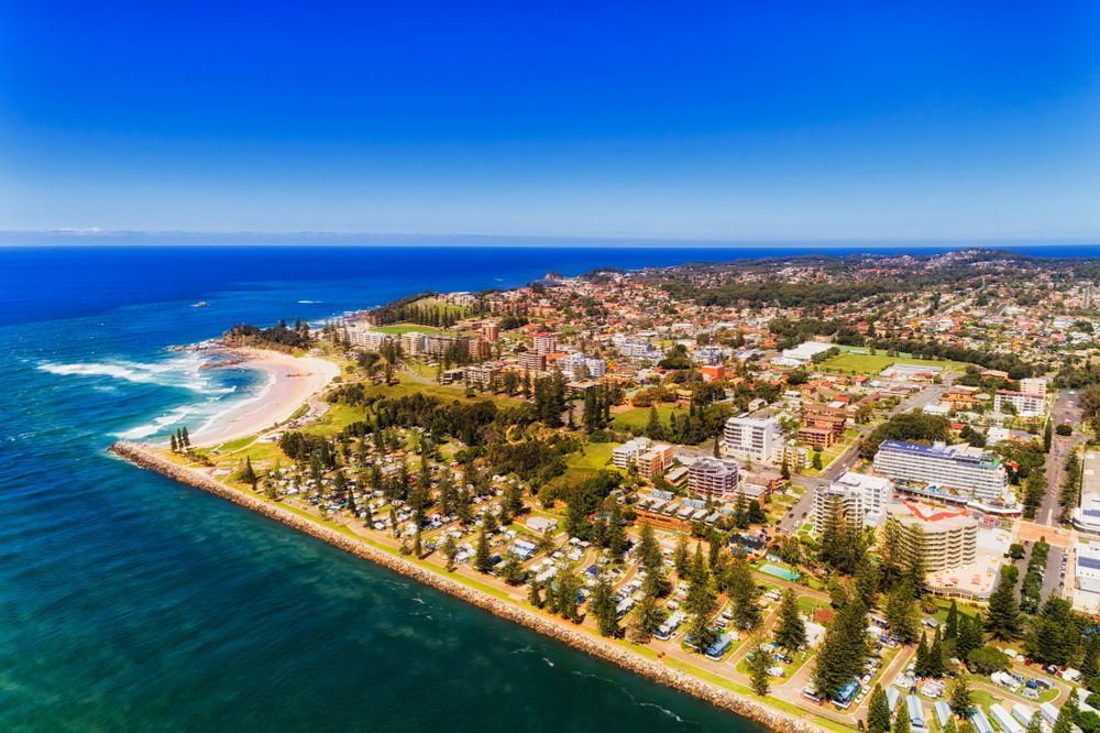 A Coastal City With a Sandy Beach and Residential Buildings — Banksia Turf In Port Macquarie, NSW