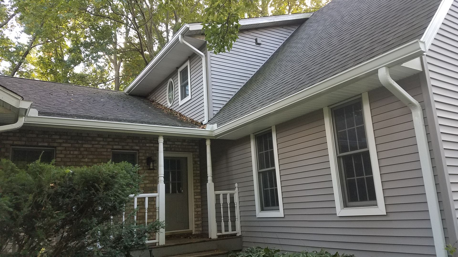 The front of a house with a porch and a roof.