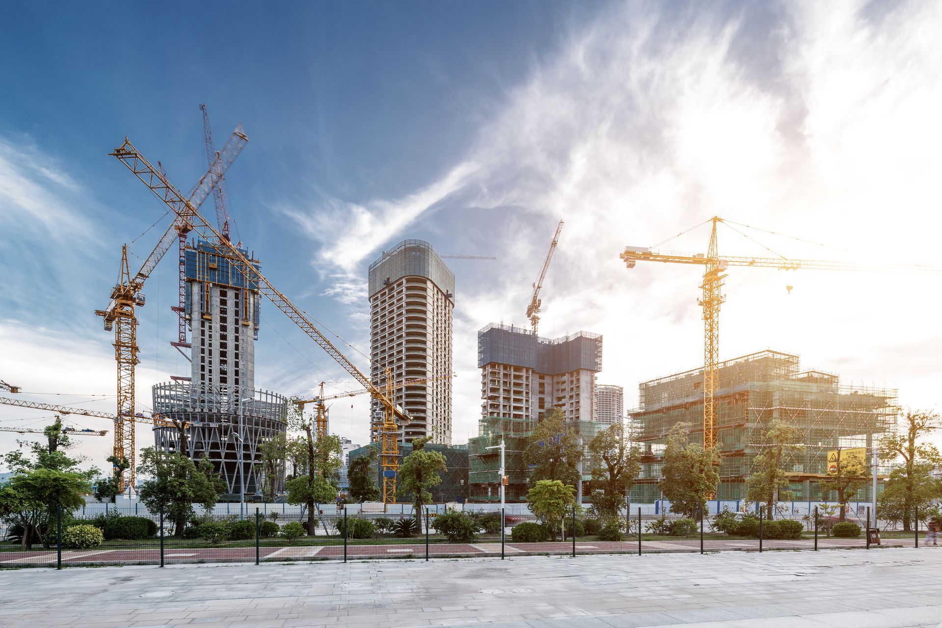 Un chantier avec beaucoup de grues et de bâtiments en construction.