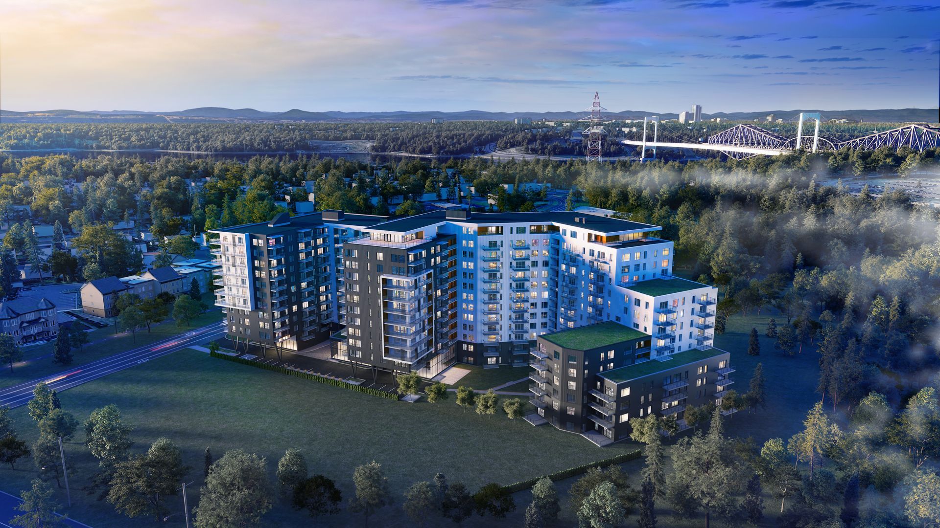 Une vue aérienne d'un grand immeuble d'appartements entouré d'arbres.