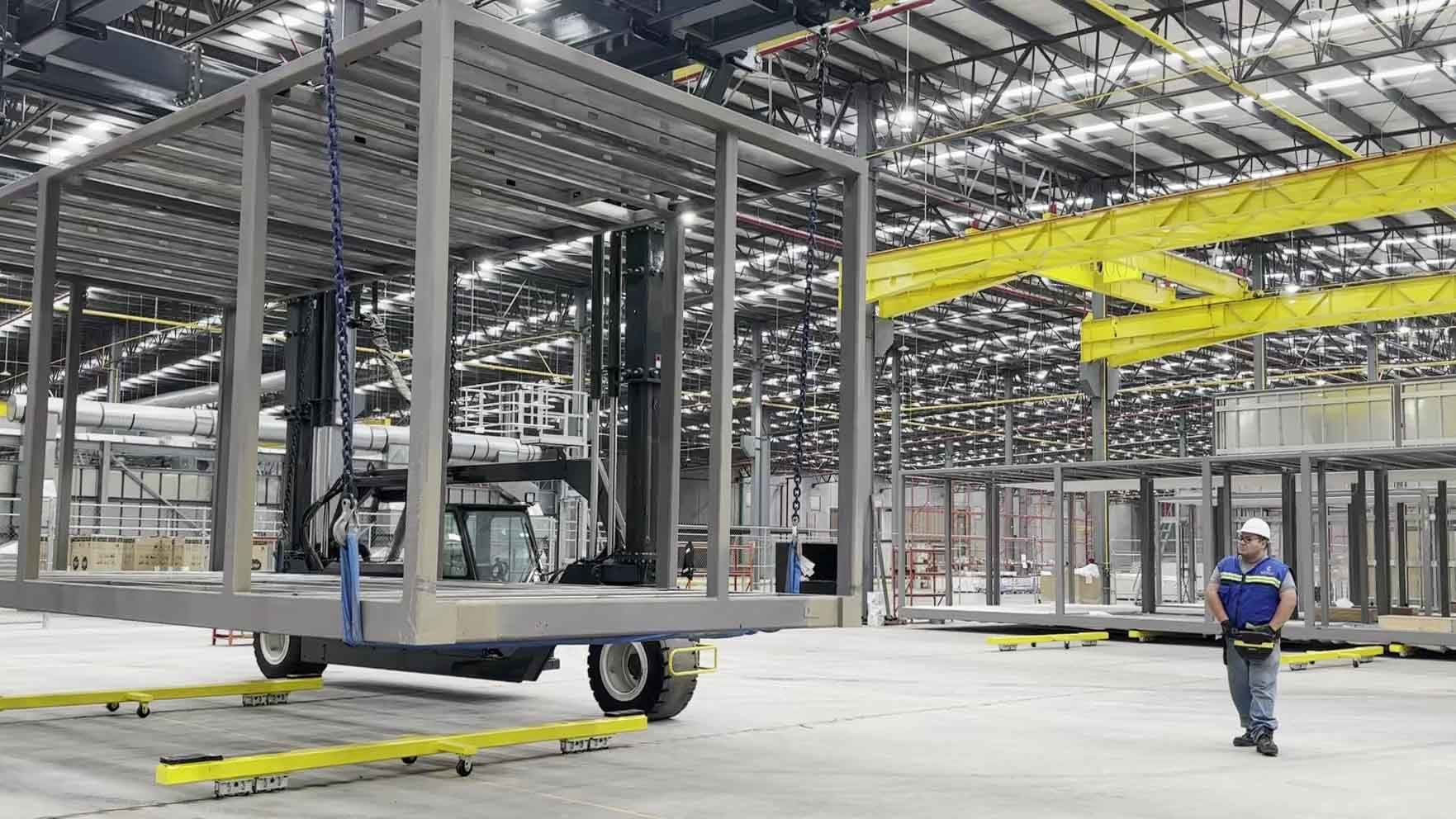 A worker surveys the West Modular factory, fabricating a number of modular structures