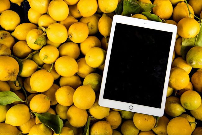 image of a tablet on top of lemons
